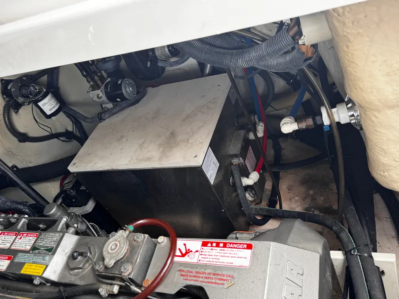 Slide: The Image of Engine compartment of a boat with various mechanical components and hoses. - 21
