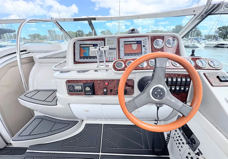 Slide: The Image of The cockpit of a 2004 Formula 40 Performance Cruiser with a wooden steering wheel and modern instruments. - 10