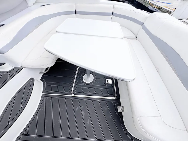 Slide: The Image of The image shows a boat seating area with white upholstery and a central table. - 12