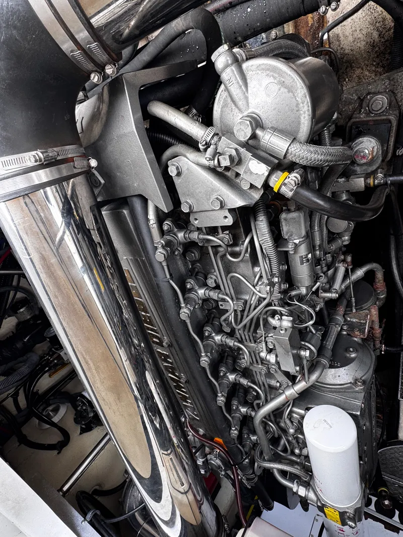 Slide: The Image of Close-up of a complex boat engine with shiny metal parts and hoses. - 23