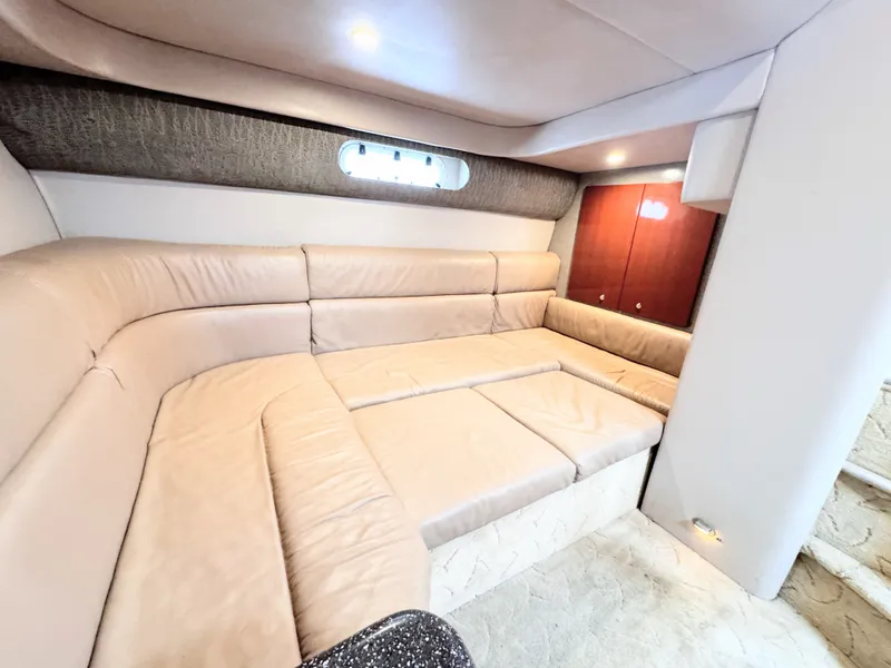 Slide: The Image of Interior of the 2004 Formula 40 Performance Cruiser with beige leather sofa and wooden cabinetry. - 16