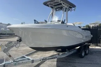 Slide: The Image of 2023 Crownline 220 CC Finseeker boat on trailer, parked outdoors. - 4