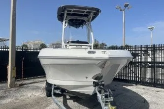 Slide: The Image of 2023 Crownline 220 CC Finseeker boat on trailer, parked outdoors. - 3