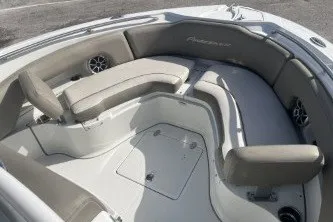 Slide: The Image of 2023 Crownline 220 CC Finseeker boat interior with cushioned seating and storage compartments. - 10