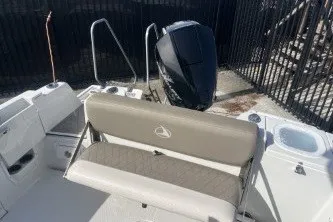 Slide: The Image of 2023 Crownline 220 CC Finseeker boat interior with seating and outboard motor. - 13