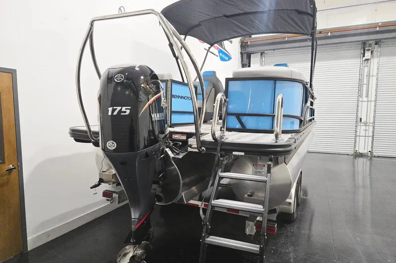 Slide: The Image of 2026 Bennington 23 S STERN RADIUS pontoon boat with Yamaha 175 engine in a showroom. - 3