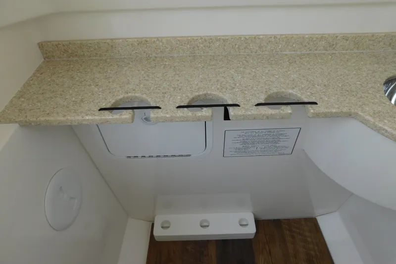 Slide: The Image of Interior of 2026 Regulator 31 boat featuring a beige countertop and storage compartments. - 41