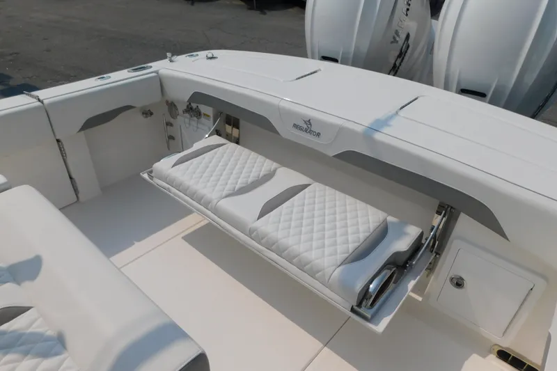 Slide: The Image of 2026 Regulator 31 boat interior with cushioned seating and storage compartments. - 18