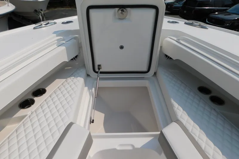 Slide: The Image of 2026 Regulator 31 boat interior with open storage compartment and quilted seating. - 32