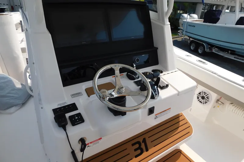 Slide: The Image of Helm of 2026 Regulator 31 boat with dual screens and modern controls. - 4