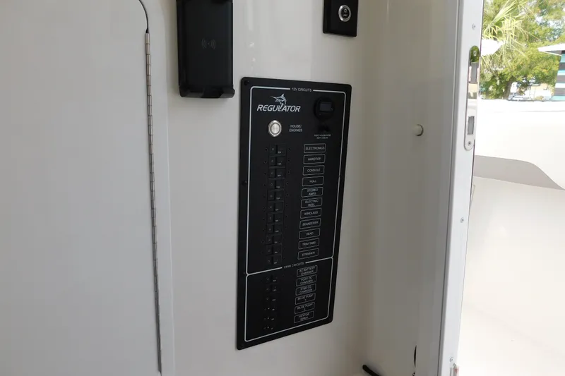 Slide: The Image of Control panel of a 2026 Regulator 31 boat, featuring various circuit switches. - 43