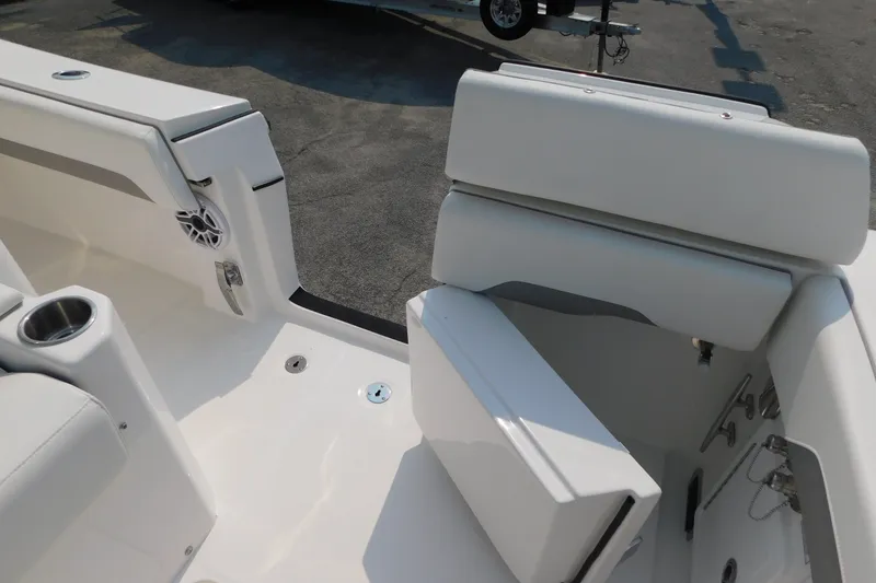 Slide: The Image of 2026 Regulator 31 boat interior with white seating and cup holder. - 12