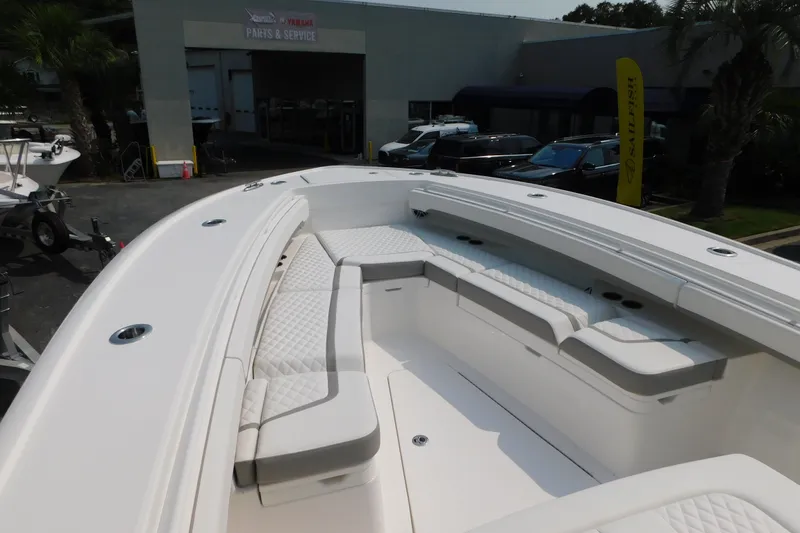 Slide: The Image of 2026 Regulator 31 boat with spacious seating, parked near service center. - 30
