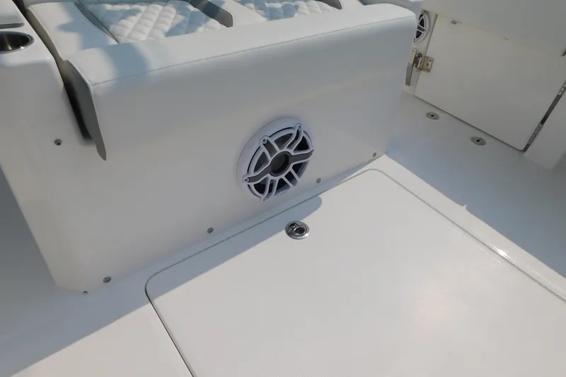 Slide: The Image of 2026 Regulator 31 boat interior with speaker and cushioned seating. - 19