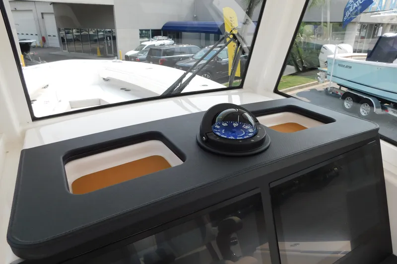 Slide: The Image of 2026 Regulator 31 boat interior with compass and dashboard view. - 49