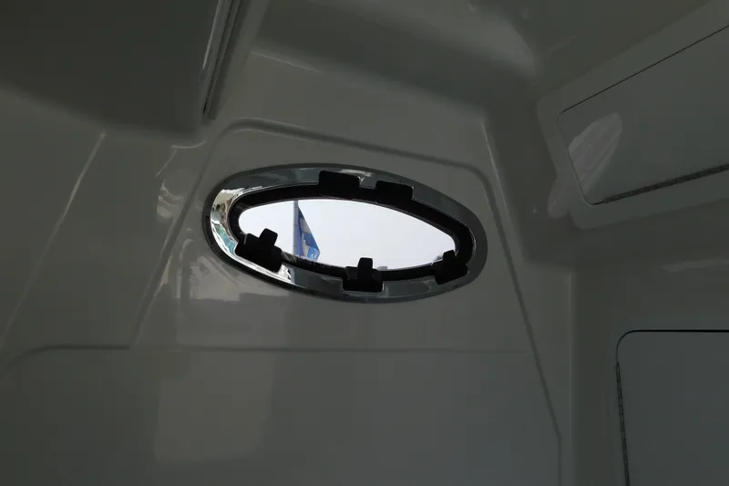 Slide: The Image of Interior view of a 2026 Regulator 31 boat, featuring an oval porthole window. - 48