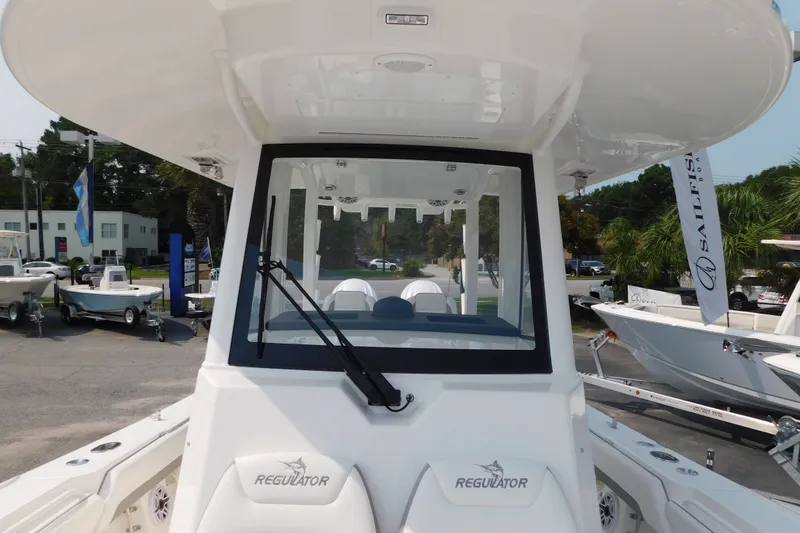 Slide: The Image of 2026 Regulator 31 boat with sleek design, showcased at a dealership. - 33