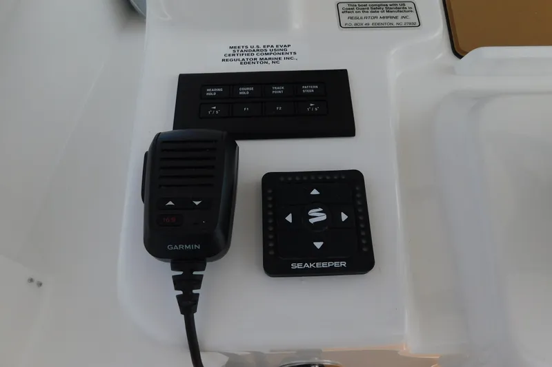 Slide: The Image of Control panel of a 2026 Regulator 31 boat featuring Garmin and Seakeeper devices. - 26