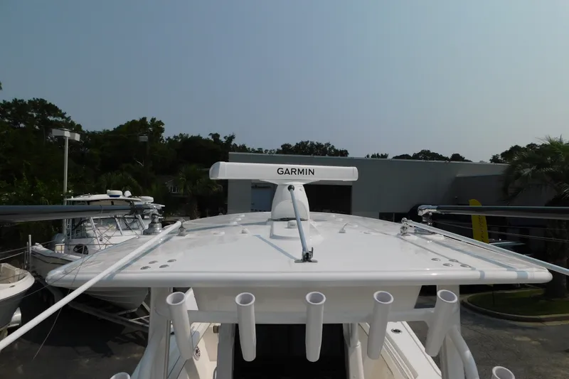 Slide: The Image of 2026 Regulator 31 boat with Garmin radar, docked outdoors. - 52