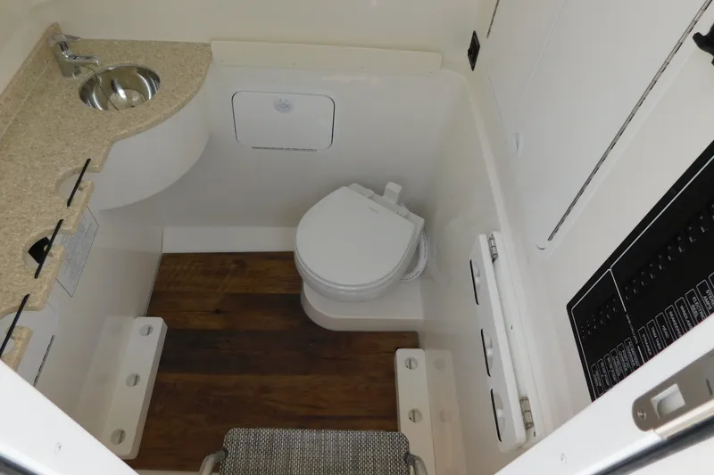 Slide: The Image of Interior of 2026 Regulator 31 boat bathroom with sink, toilet, and wood flooring. - 39