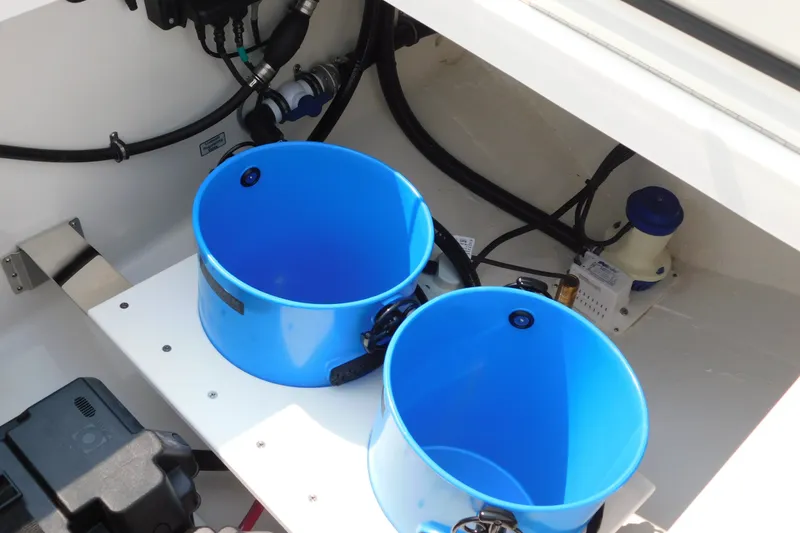 Slide: The Image of Interior view of 2026 Regulator 31 boat with blue buckets and wiring. - 21