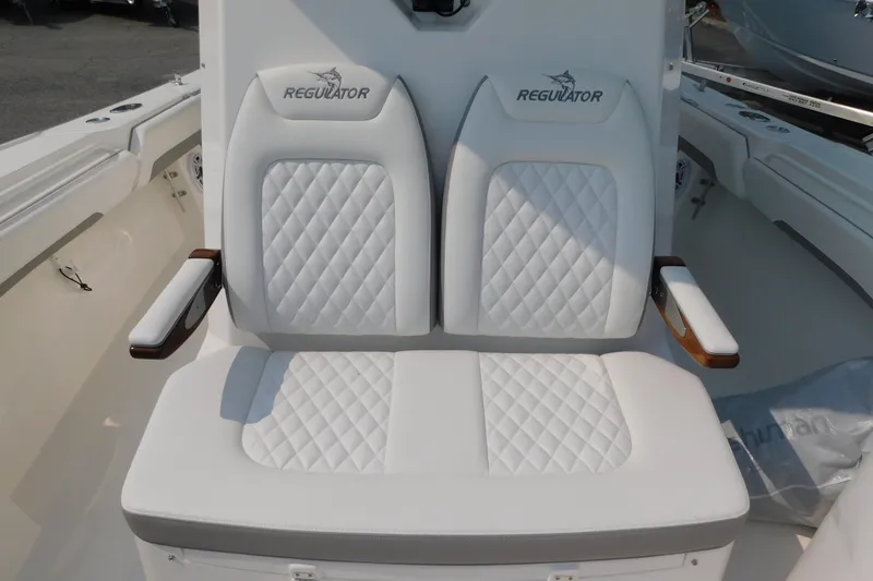 Slide: The Image of Luxury seating on 2026 Regulator 31 boat with quilted white upholstery and armrests. - 9