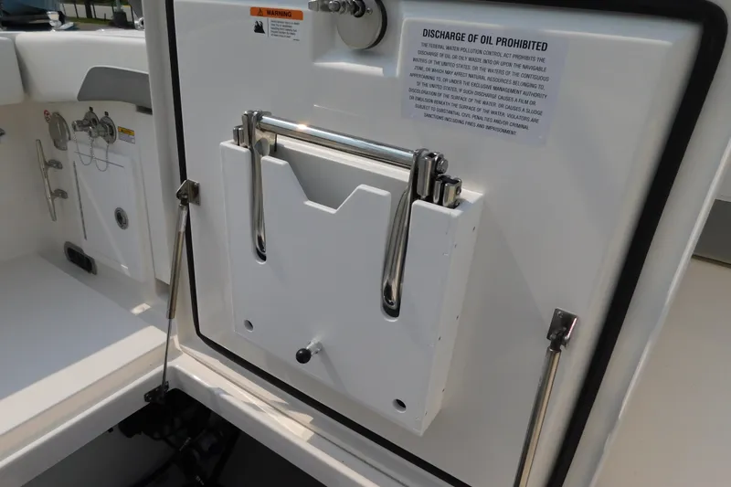 Slide: The Image of 2026 Regulator 31 boat interior with oil discharge warning sign and stainless steel fittings. - 24