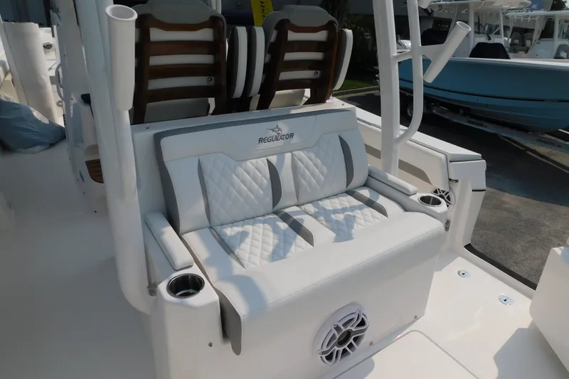 Slide: The Image of 2026 Regulator 31 boat seating area with white quilted upholstery and cup holders. - 8
