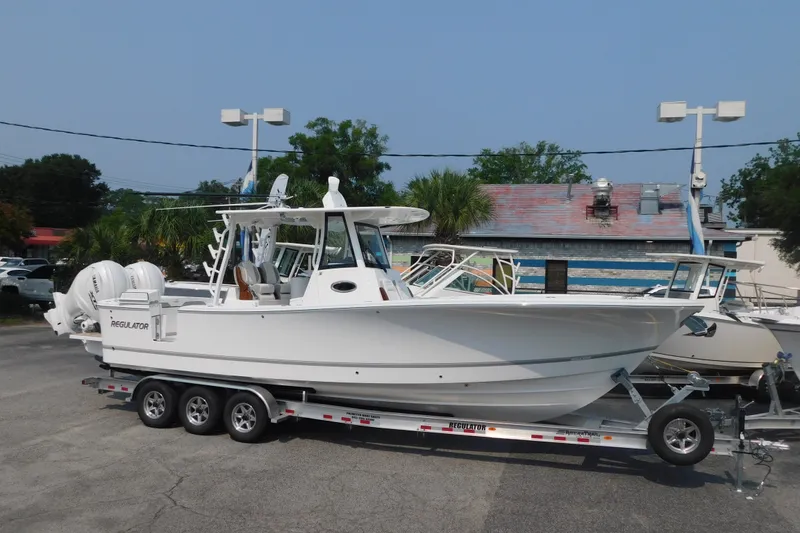 The Image of 2026 Regulator 31 boat on trailer, parked outdoors in a dealership lot. - 0