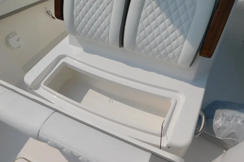 Slide: The Image of 2026 Regulator 31 boat seat with white quilted upholstery and storage compartment. - 11
