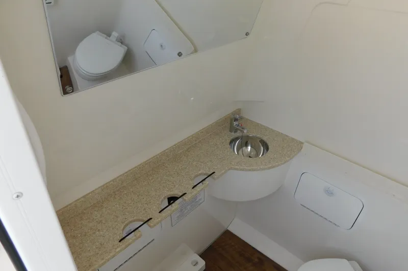 Slide: The Image of 2026 Regulator 31 boat bathroom with sink, toilet, and mirror. - 38