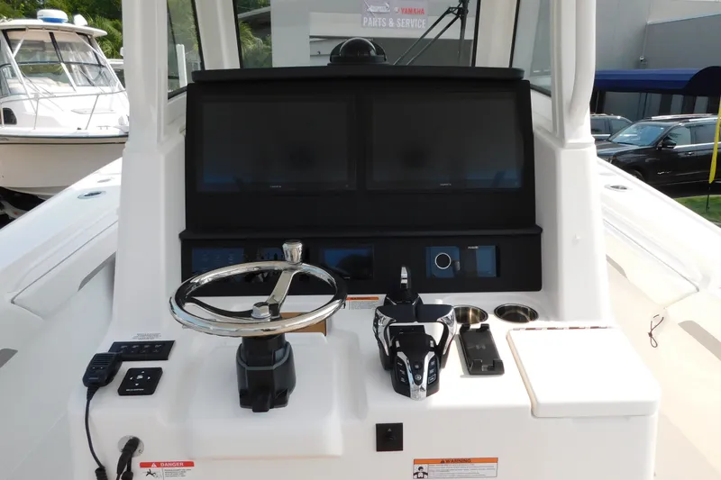 Slide: The Image of 2026 Regulator 31 boat helm with dual screens and modern controls. - 3