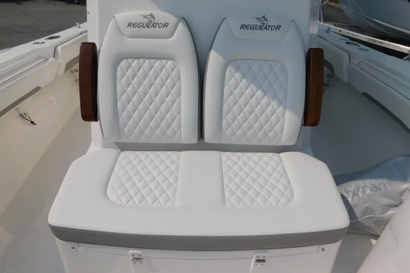 Slide: The Image of 2026 Regulator 31 boat seating with white quilted upholstery and Regulator logo. - 10