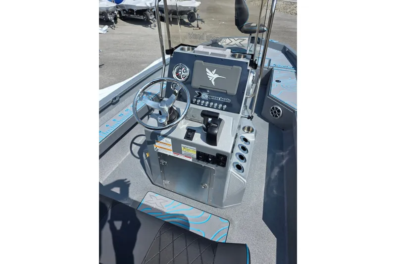 Slide: The Image of 2027 Xpress H20B Bay boat console with steering wheel and control panel. - 16