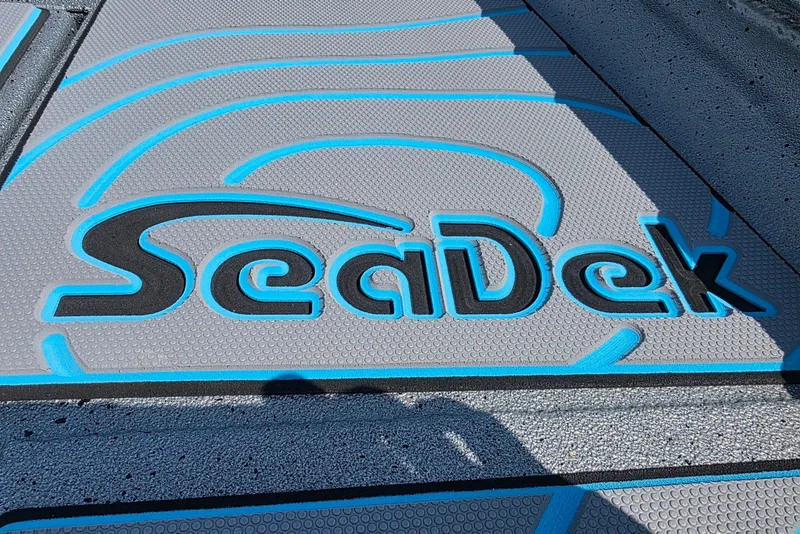 Slide: The Image of SeaDek logo on Xpress H20B Bay boat deck, 2027 model, with blue and gray design. - 9
