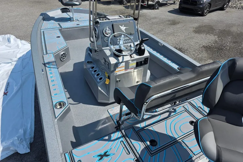 Slide: The Image of 2027 Xpress H20B Bay boat interior with modern dashboard and seating. - 6