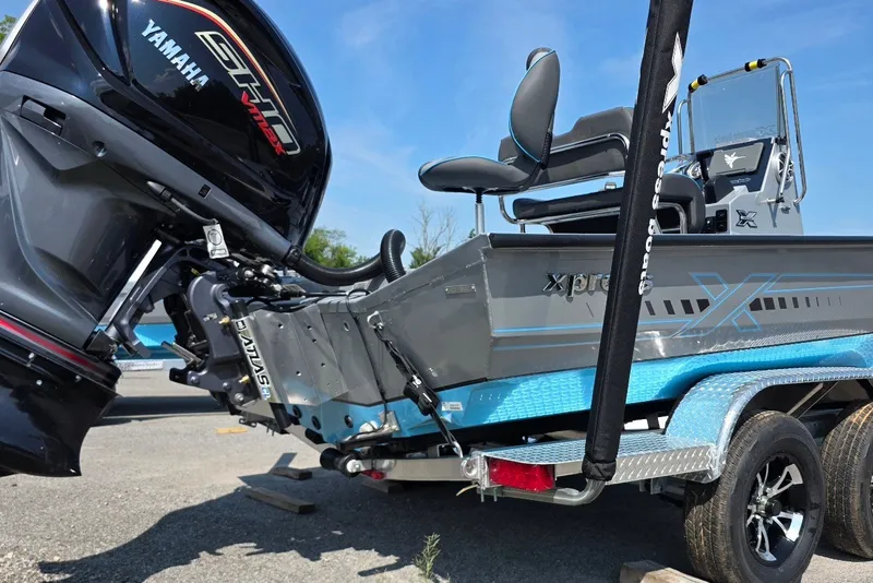 Slide: The Image of 2027 Xpress H20B Bay boat with Yamaha engine on trailer, featuring sleek design and modern features. - 3