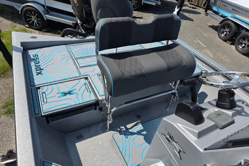 Slide: The Image of 2027 Xpress H20B Bay boat interior with seating and steering wheel. - 12