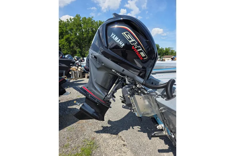 Slide: The Image of 2027 Xpress H20B Bay boat with Yamaha VMAX SHO outboard motor, parked outdoors. - 4