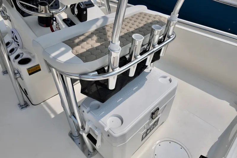 Slide: The Image of 2027 Bulls Bay 2200 XS boat interior with rod holders and cooler. - 4
