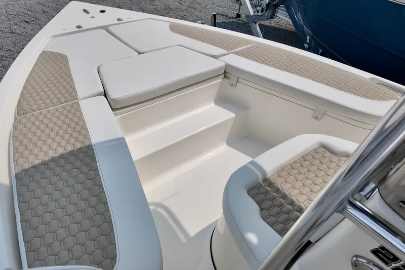 Slide: The Image of 2027 Bulls Bay 2200 XS boat interior with cushioned seating and non-slip flooring. - 10