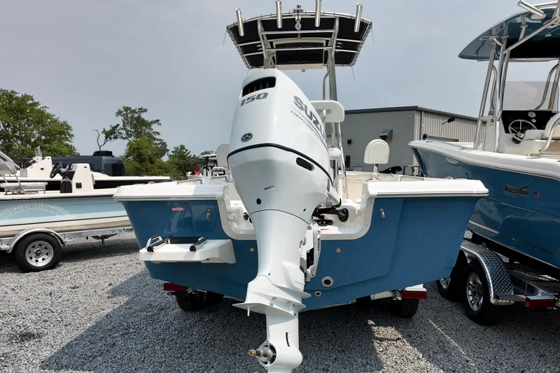 Slide: The Image of 2027 Bulls Bay 2200 XS boat with Suzuki 150 outboard motor, parked on gravel. - 11