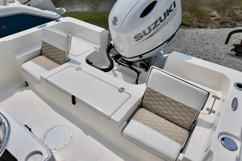 Slide: The Image of 2027 Bulls Bay 2200 XS boat interior with Suzuki engine, featuring cushioned seating. - 6