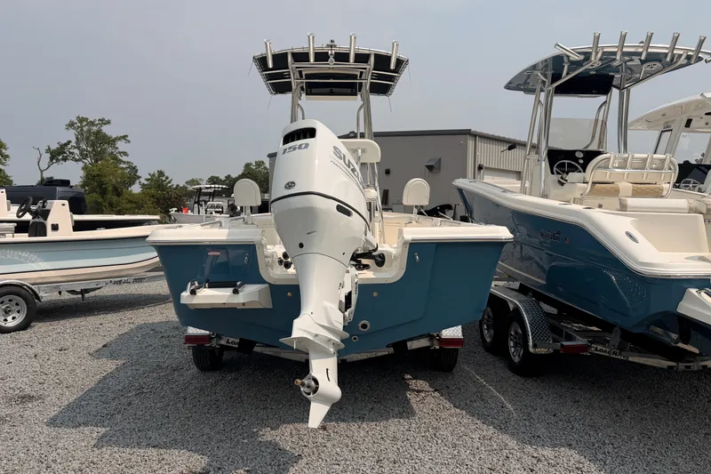 Slide: The Image of 2027 Bulls Bay 2200 XS boat with Suzuki 150 engine on trailer, parked outdoors. - 3