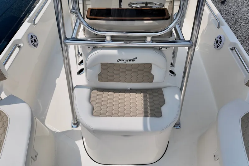 Slide: The Image of 2027 Bulls Bay 2200 XS boat interior with cushioned seating and stainless steel railings. - 9