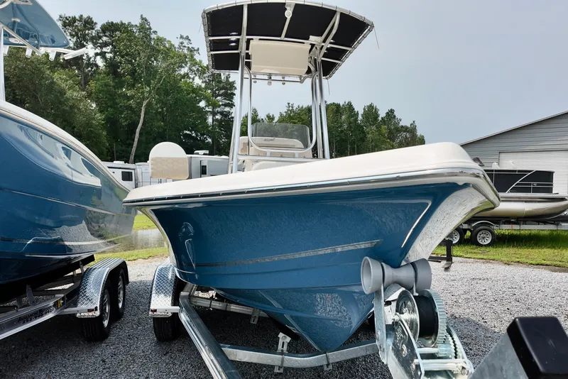 Slide: The Image of 2027 Bulls Bay 2200 XS boat on trailer, blue hull, parked outdoors. - 2