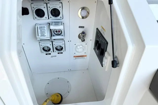 Slide: The Image of Electrical panel of 2027 Sea Ray Sundancer 320 boat, featuring multiple outlets and controls. - 18