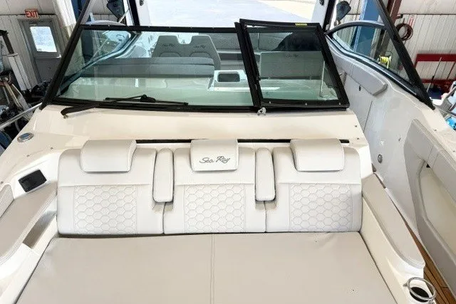 Slide: The Image of 2027 Sea Ray Sundancer 320 interior with white seating and windshield view. - 4