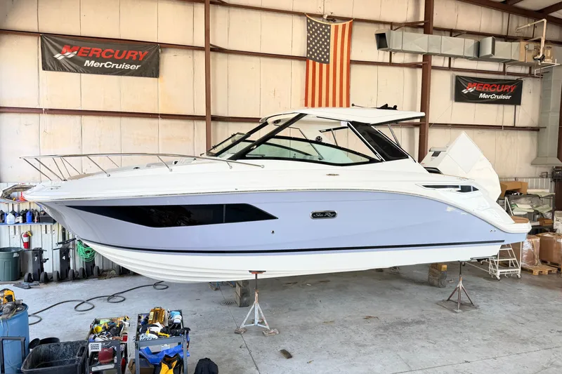 Slide: The Image of 2027 Sea Ray Sundancer 320 yacht in a workshop, featuring sleek design and modern amenities. - 19