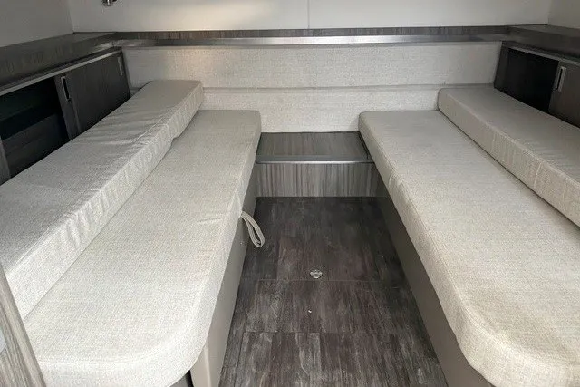 Slide: The Image of Interior cabin of 2027 Sea Ray Sundancer 320 with beige seating and wood flooring. - 11